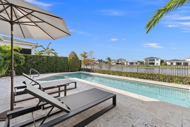 13689 Artisan Cir, Palm Beach Gardens, FL 33418 - view of pool with a fenced backyard, a patio, a residential view, and a water view