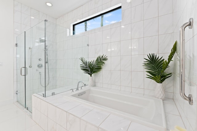 bathroom featuring tile walls and plus walk in shower