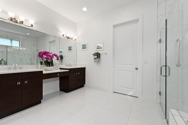 bathroom featuring walk in shower, vanity, and tile patterned flooring