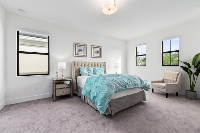 bedroom featuring light colored carpet