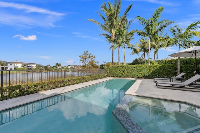 view of pool featuring a patio area and a water view