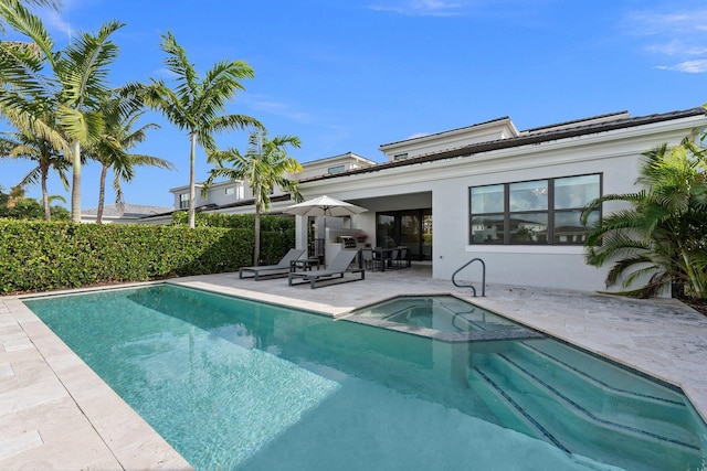 back of house featuring a fenced in pool and a patio