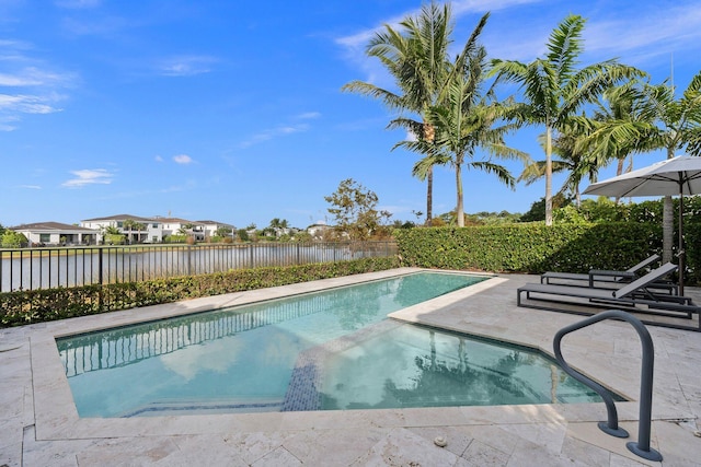 view of swimming pool featuring a patio area and a water view