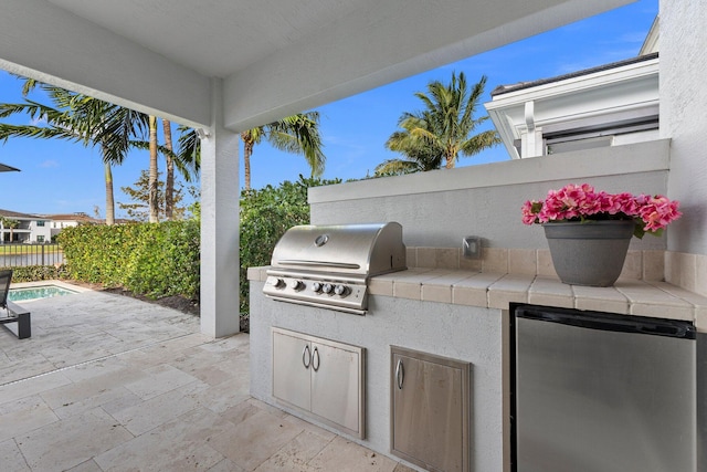 view of patio with an outdoor kitchen and area for grilling