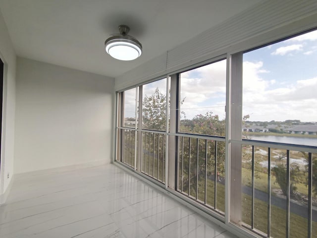 unfurnished sunroom with a water view and a healthy amount of sunlight