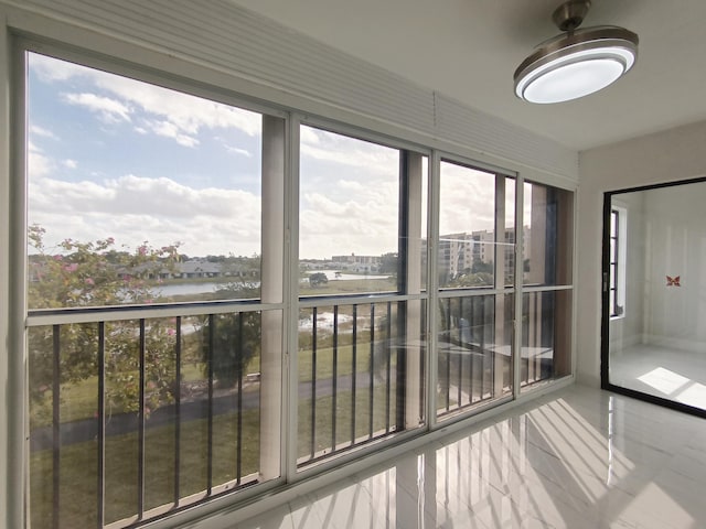 unfurnished sunroom with a water view