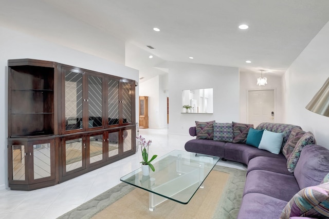 tiled living room with a chandelier and vaulted ceiling