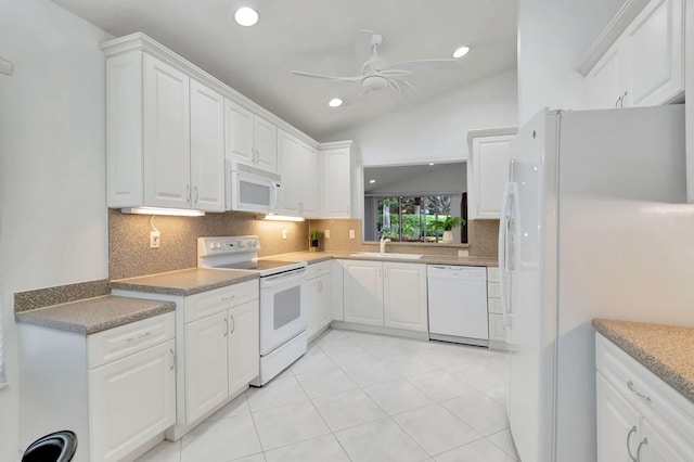 kitchen with lofted ceiling, white cabinets, decorative backsplash, sink, and white appliances