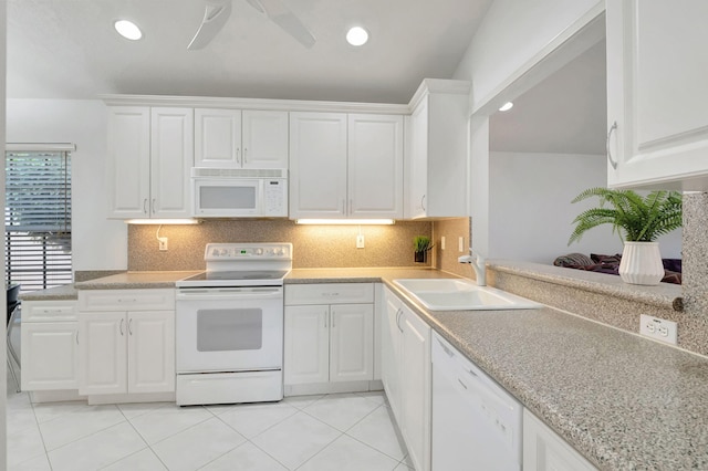 kitchen with white cabinets, tasteful backsplash, sink, and white appliances