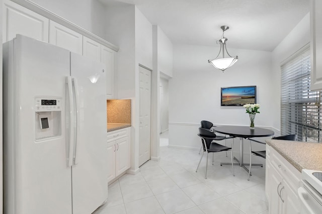 kitchen with pendant lighting, white cabinetry, white appliances, and light tile patterned flooring