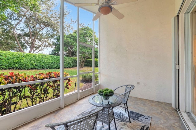 sunroom / solarium with a healthy amount of sunlight and ceiling fan