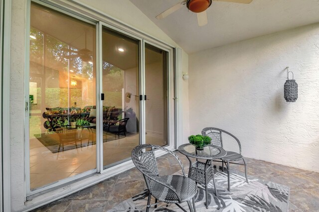 sunroom with a healthy amount of sunlight, lofted ceiling, and ceiling fan