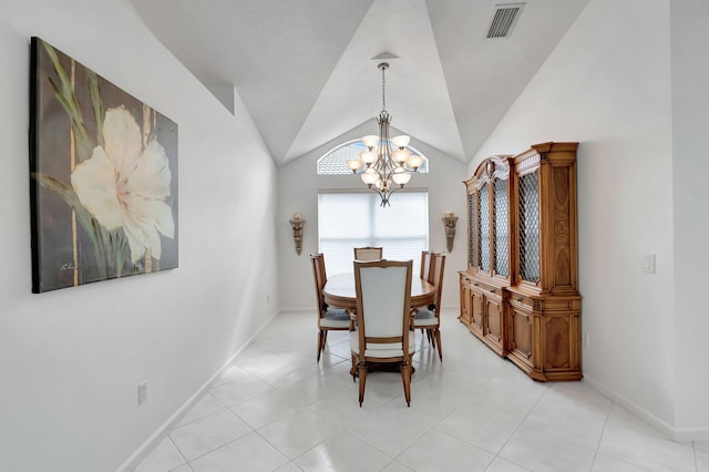 tiled dining space with an inviting chandelier and lofted ceiling