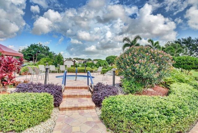 surrounding community with a pool and a patio area