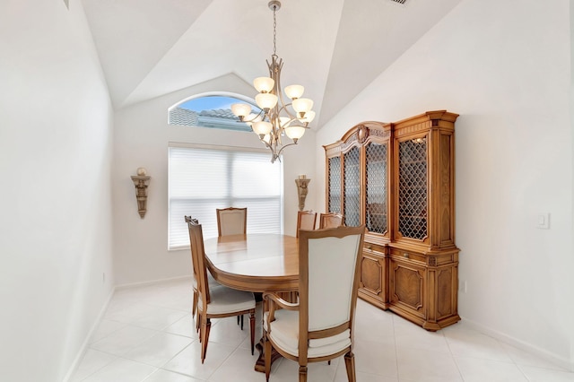 dining area with high vaulted ceiling, an inviting chandelier, and light tile patterned flooring