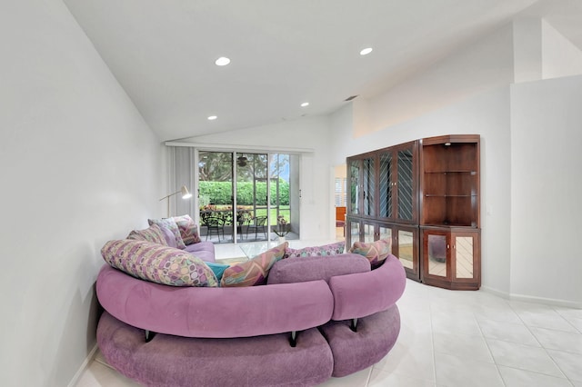 living room featuring lofted ceiling and light tile patterned floors