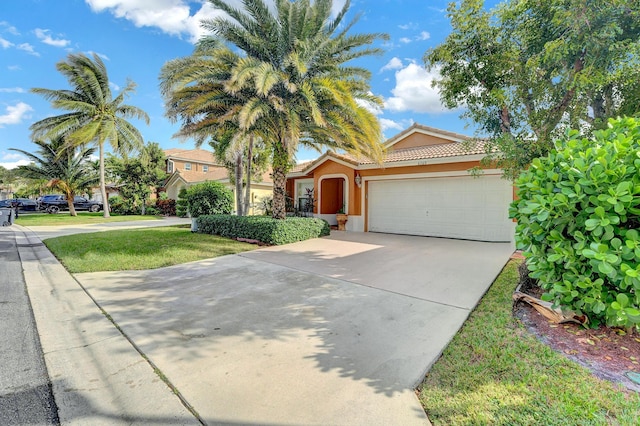 view of front of home featuring a garage and a front lawn