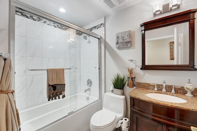 full bathroom featuring toilet, vanity, and shower / bath combination with glass door