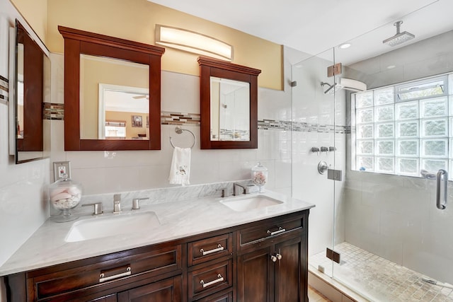 bathroom featuring vanity and an enclosed shower