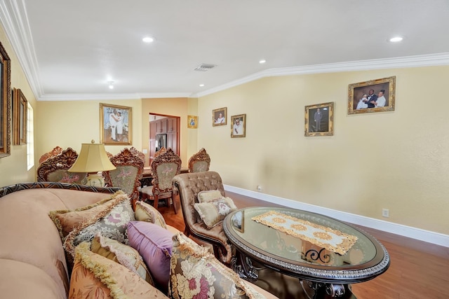 living room featuring hardwood / wood-style flooring, vaulted ceiling, and crown molding