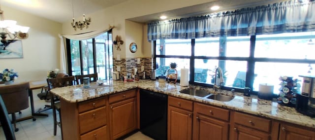 kitchen with dishwasher, kitchen peninsula, sink, light tile patterned floors, and pendant lighting