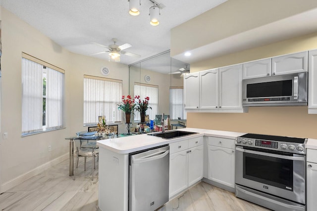 kitchen with white cabinets, sink, and stainless steel appliances