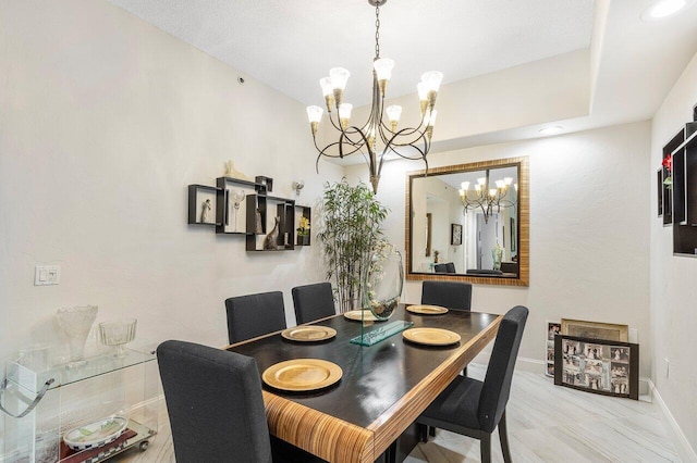 dining room with light hardwood / wood-style floors and a notable chandelier