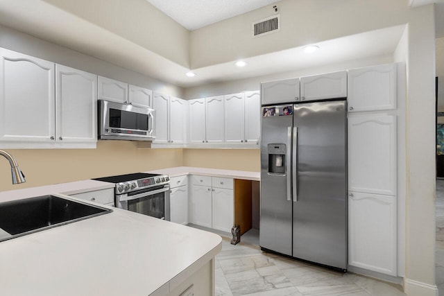 kitchen featuring sink, white cabinetry, and stainless steel appliances