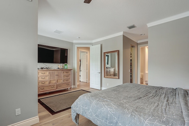 bedroom with connected bathroom, light wood-type flooring, ceiling fan, and ornamental molding