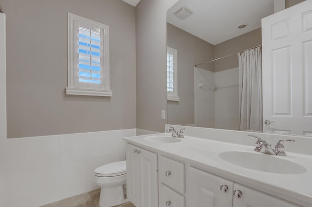 bathroom with tile patterned flooring, vanity, toilet, and a shower with shower curtain