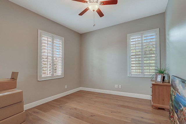 unfurnished bedroom featuring light wood-type flooring, multiple windows, and ceiling fan