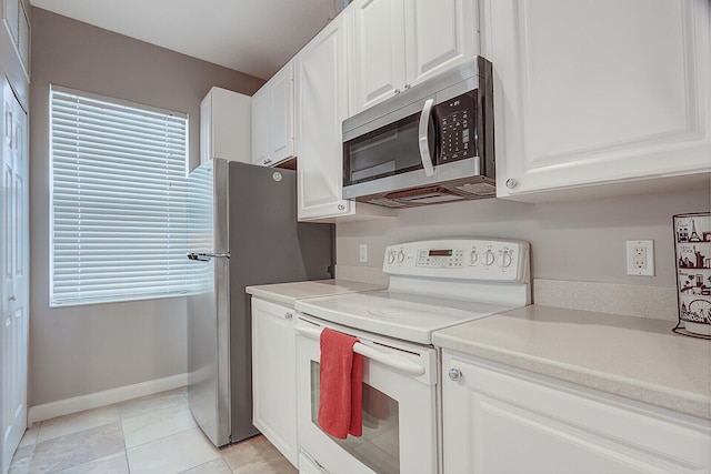 kitchen with white cabinetry, stainless steel appliances, and light tile patterned floors