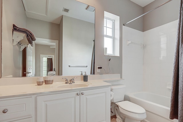 full bathroom with vanity, shower / bath combo with shower curtain, and toilet