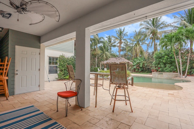 view of patio with a swimming pool with hot tub