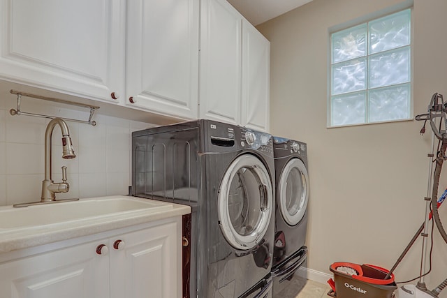 laundry room with cabinets, sink, and washing machine and clothes dryer