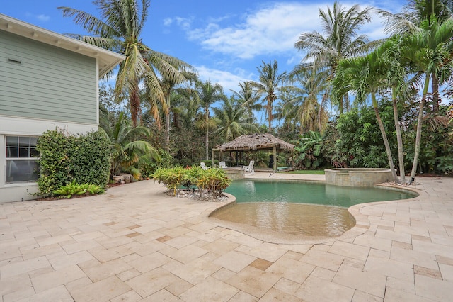 view of pool featuring an in ground hot tub, a gazebo, and a patio area