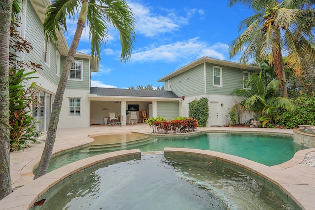 view of swimming pool featuring an in ground hot tub and a patio area