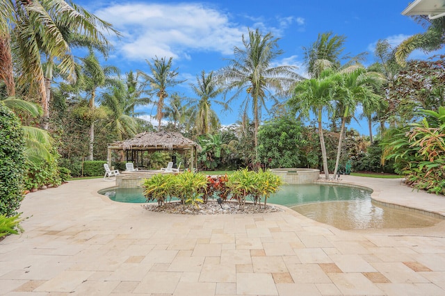 view of swimming pool featuring a patio, an in ground hot tub, and a gazebo