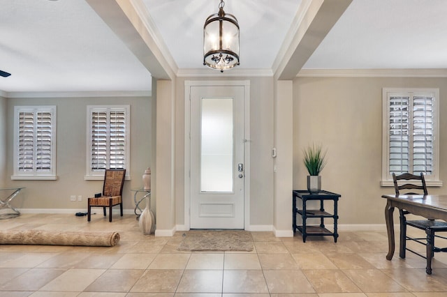 foyer featuring light tile patterned floors, an inviting chandelier, and crown molding