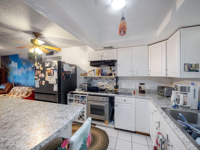 kitchen featuring white cabinets, a textured ceiling, light tile patterned floors, ceiling fan, and appliances with stainless steel finishes