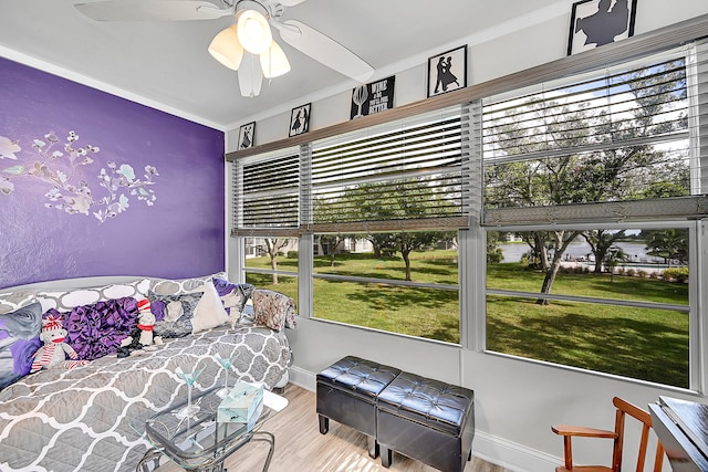 bedroom with hardwood / wood-style flooring, ceiling fan, and multiple windows