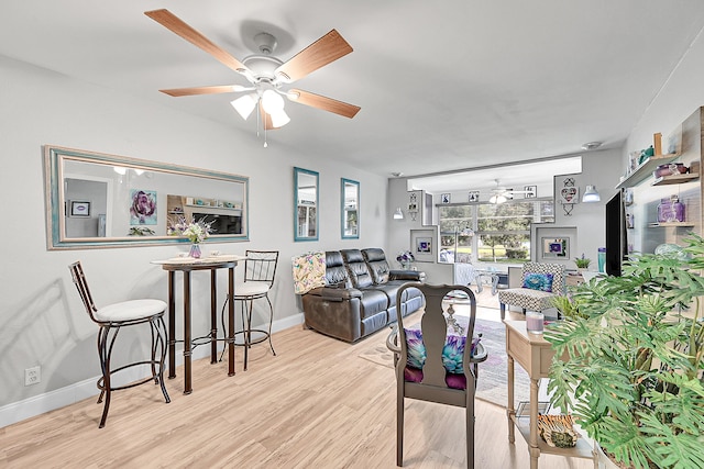 living room featuring light wood-type flooring and ceiling fan