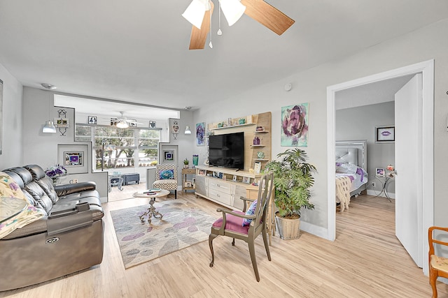 living room featuring light wood-type flooring and ceiling fan