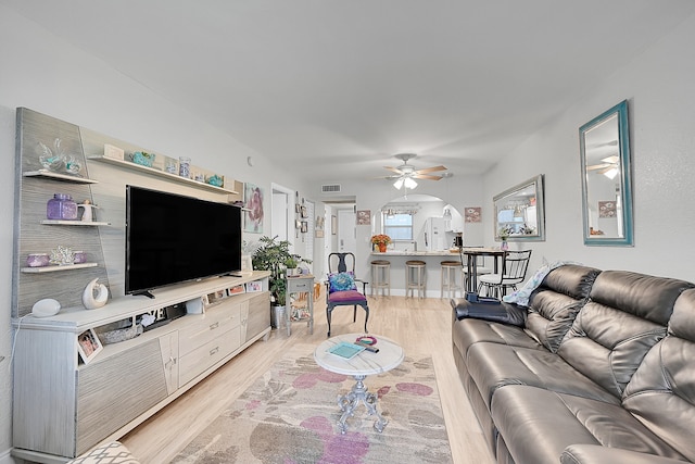 living room with ceiling fan and light hardwood / wood-style floors