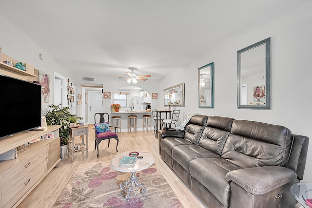 living room with light hardwood / wood-style floors and ceiling fan