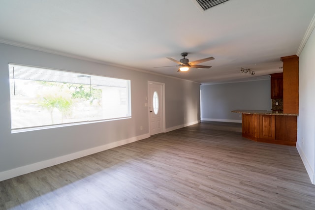 unfurnished living room with hardwood / wood-style floors, ceiling fan, and crown molding