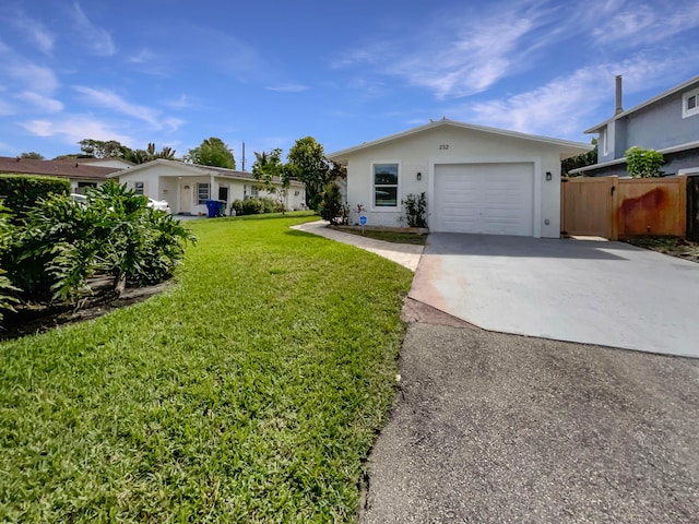 single story home with a garage and a front lawn