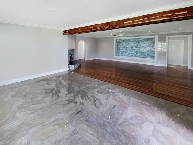 232 NW 25th St, Wilton Manors, FL 33311 - unfurnished living room featuring arched walkways, baseboards, crown molding, wood finished floors, and a ceiling fan