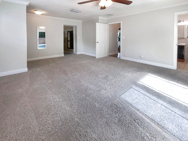 unfurnished room featuring ceiling fan, a textured ceiling, and ornamental molding