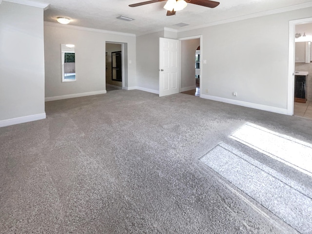 232 NW 25th St, Wilton Manors, FL 33311 - spare room with a ceiling fan, ornamental molding, baseboards, and carpet flooring